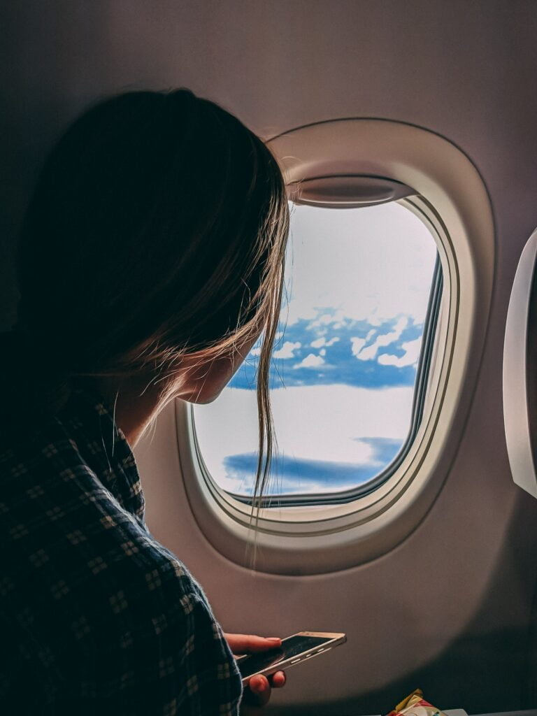 Pacific Prime_Girl looking out of airplane window