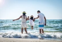 Expat Advisory_Family lifting daughter over the sea