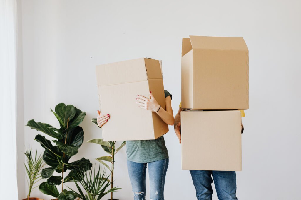 Image of man and woman cardboard boxes over face