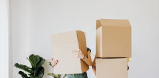 Image of man and woman cardboard boxes over face