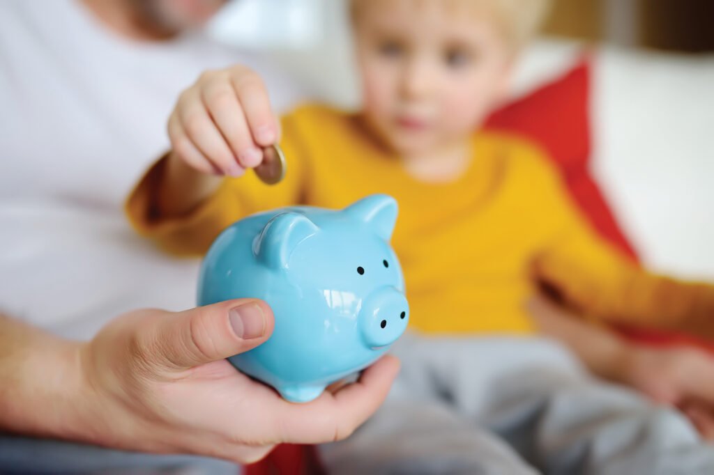 child and piggy bank