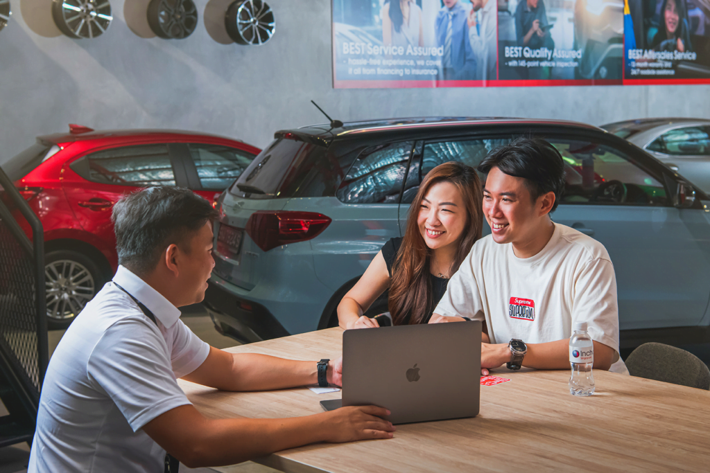 Mann and woman at car showroom