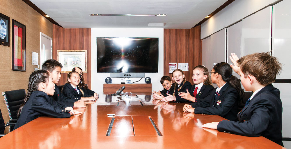 Dulwich college students debating in a conference room