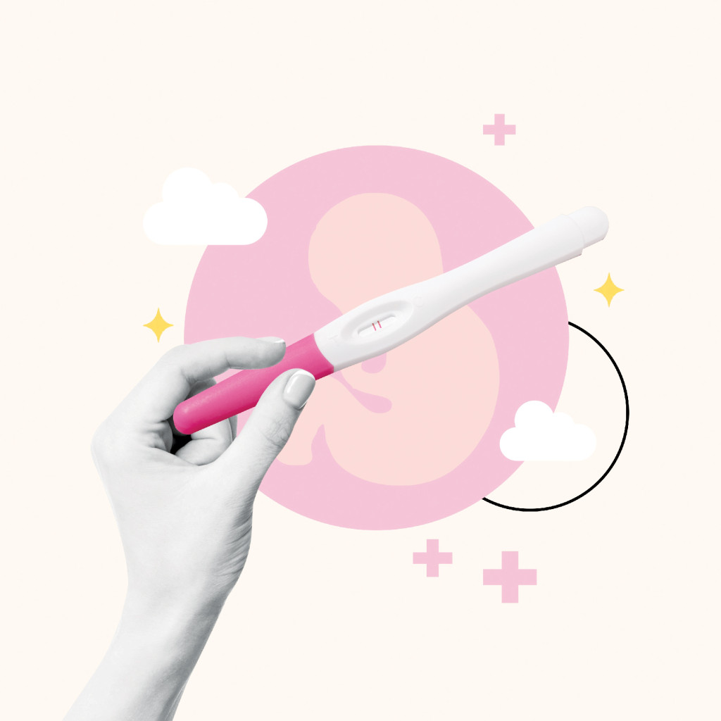 Positive pregnancy test held in hand