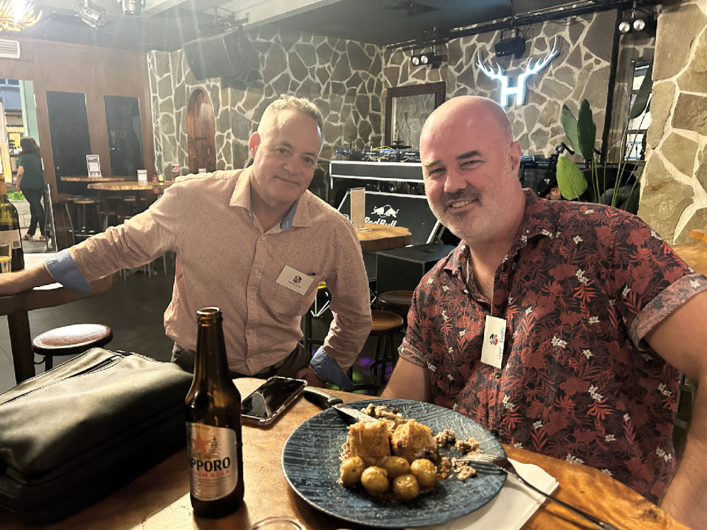 2 men having a good time over drinks and food