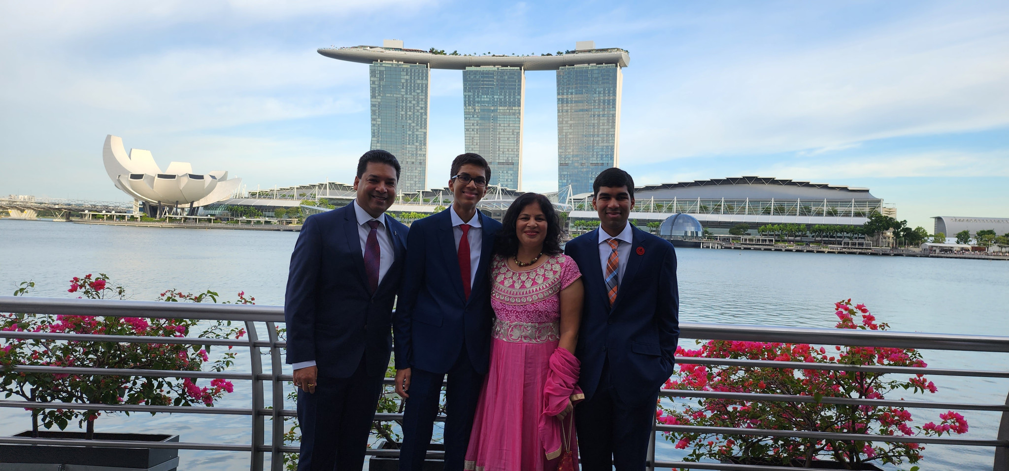 Family photo at Marina Bay Sands Singapore with the ArtScience Museum and waterfront skyline in the background