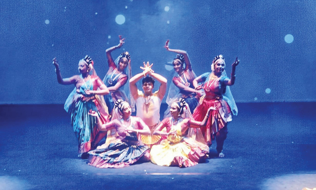 A group of classical Indian dancers performs on stage