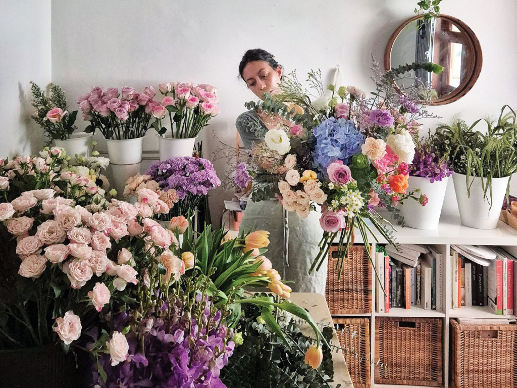 Florist arranging a roomful of flowers