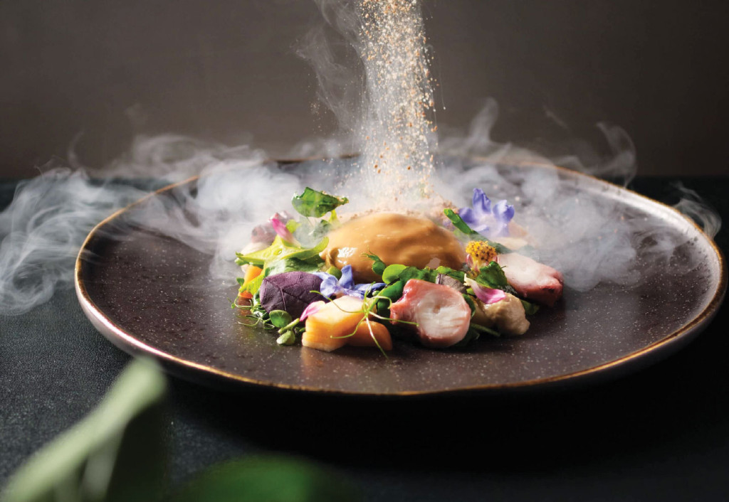 Spices onto dish of vegs