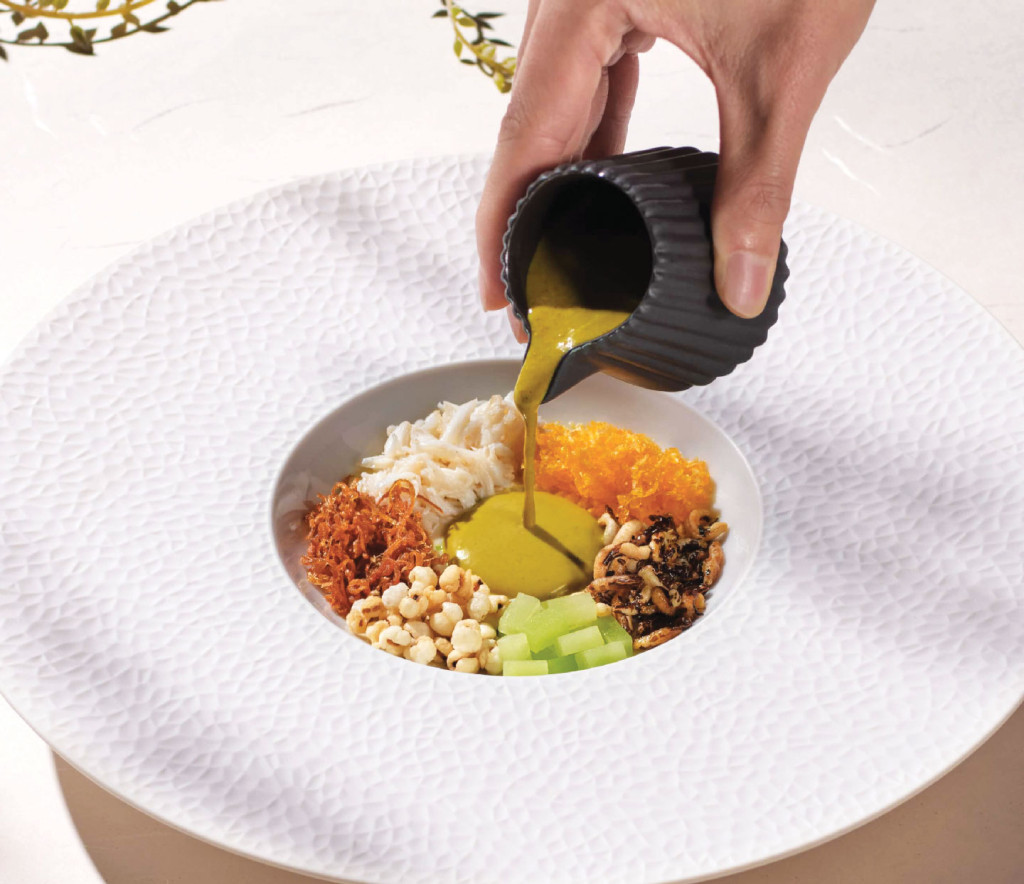 Pouring sauce into Indonesia Mud Crab dish
