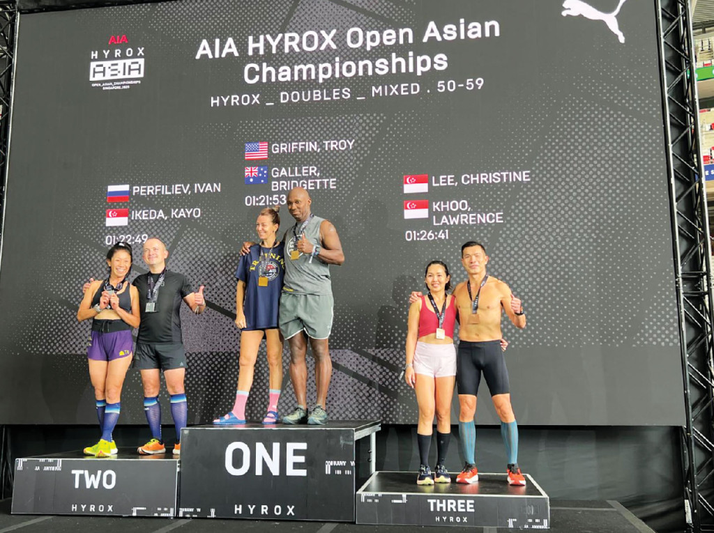 Christine and Lawrence stand proud on the podium
