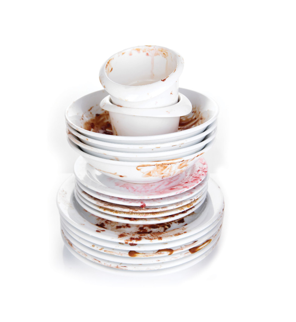A tall pile of dirty dishes