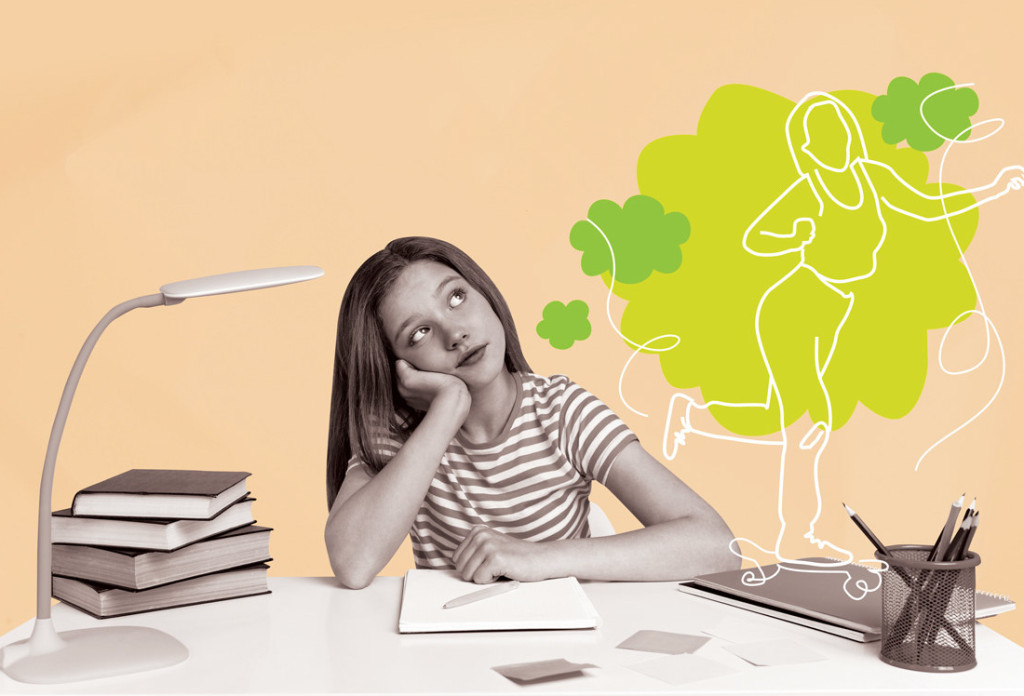 girl doing homework but daydreaming